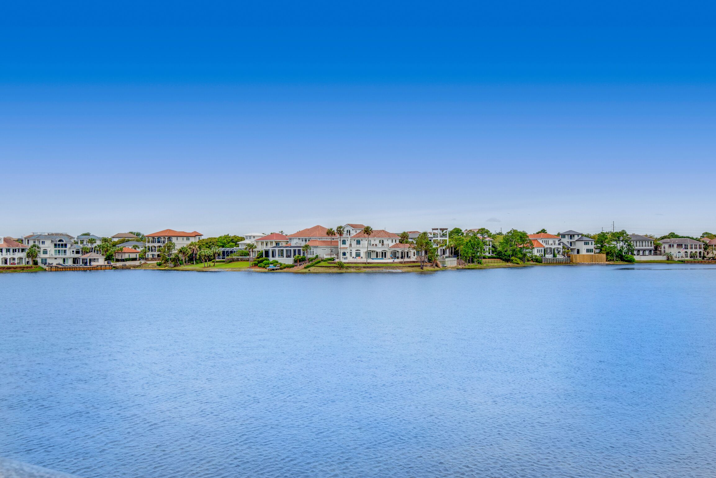 A waterfront residential area with houses along the shore.