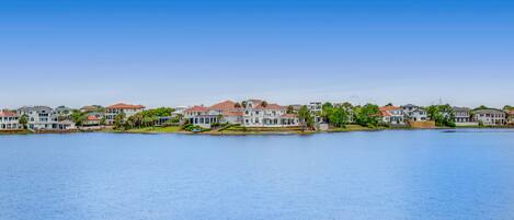A waterfront residential area with houses along the shore.
