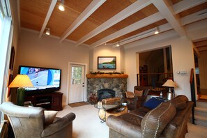 living room with gas fireplace and high ceilings - Elegant Chamberlands home with pool, beach, and tennis (Homewood)