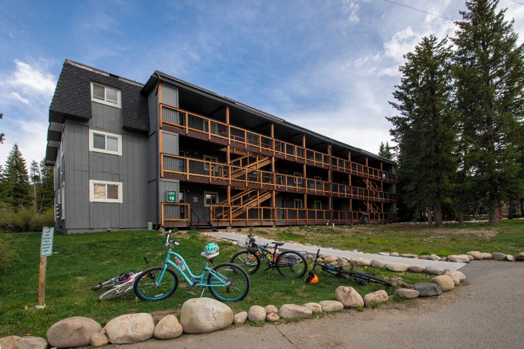 A multi-story building with a wooden staircase leading to an upper level.