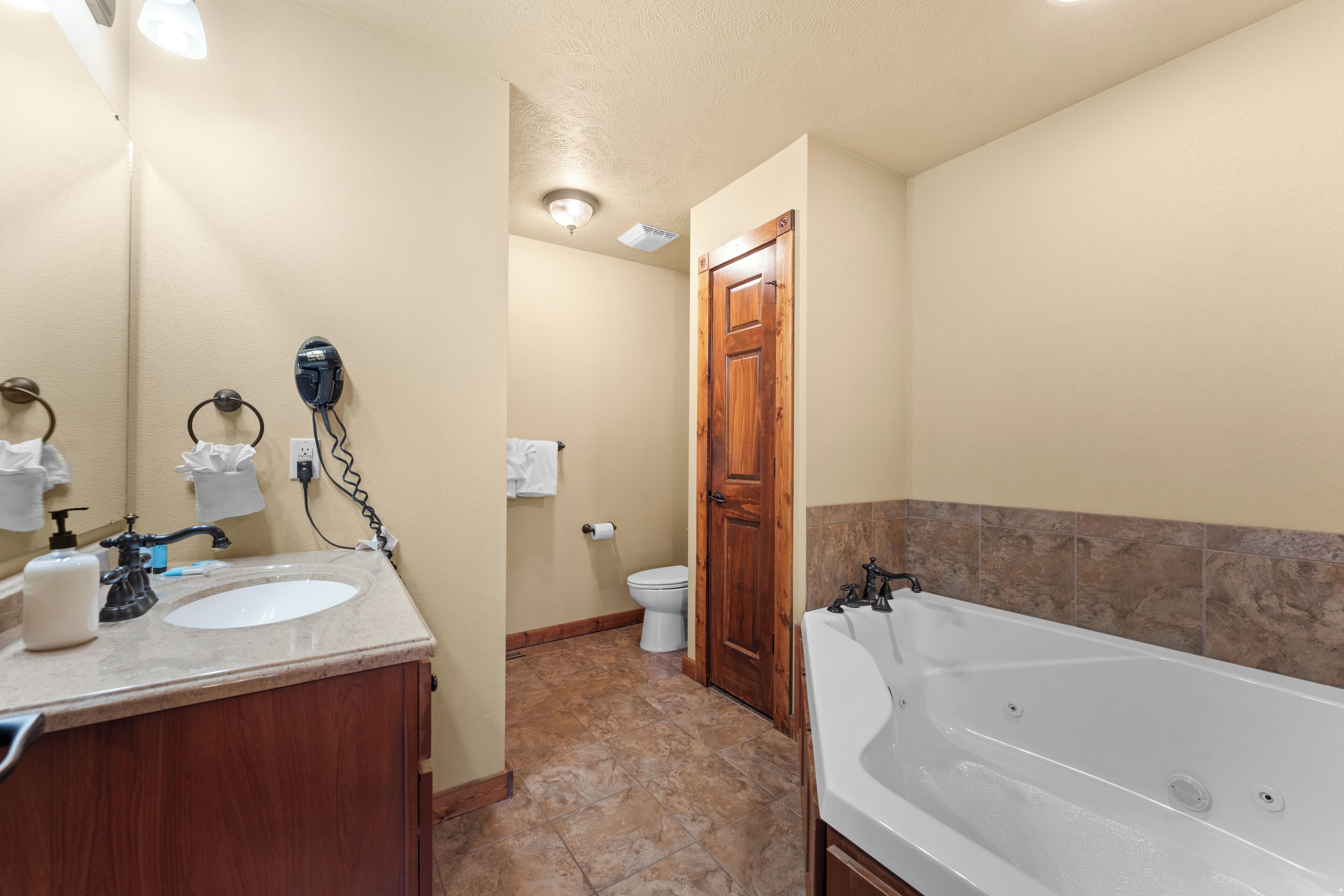 A bathroom with a sink, toilet, and bathtub.