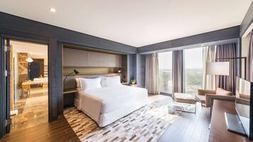 Habitación de hotel moderna con una cama grande, televisión, escritorio y vistas a la ciudad.