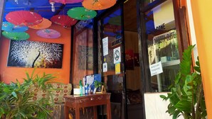 A storefront with colorful umbrellas hanging overhead, a tiled floor, and a 'Sorry we're temporarily closed' sign. - Hwan Dynasty Suite Elnido (El Nido)