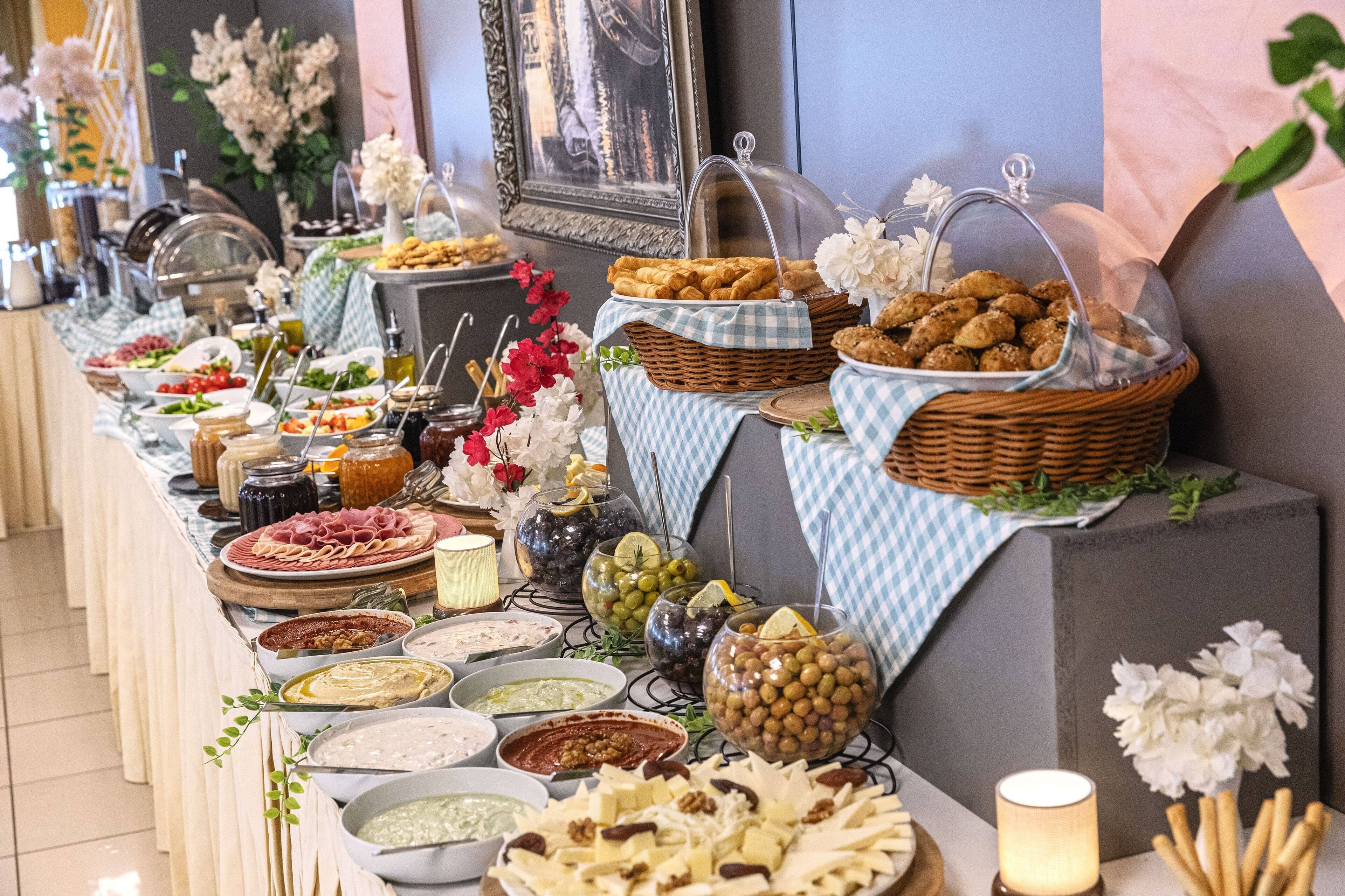 A buffet table with various food items and condiments.