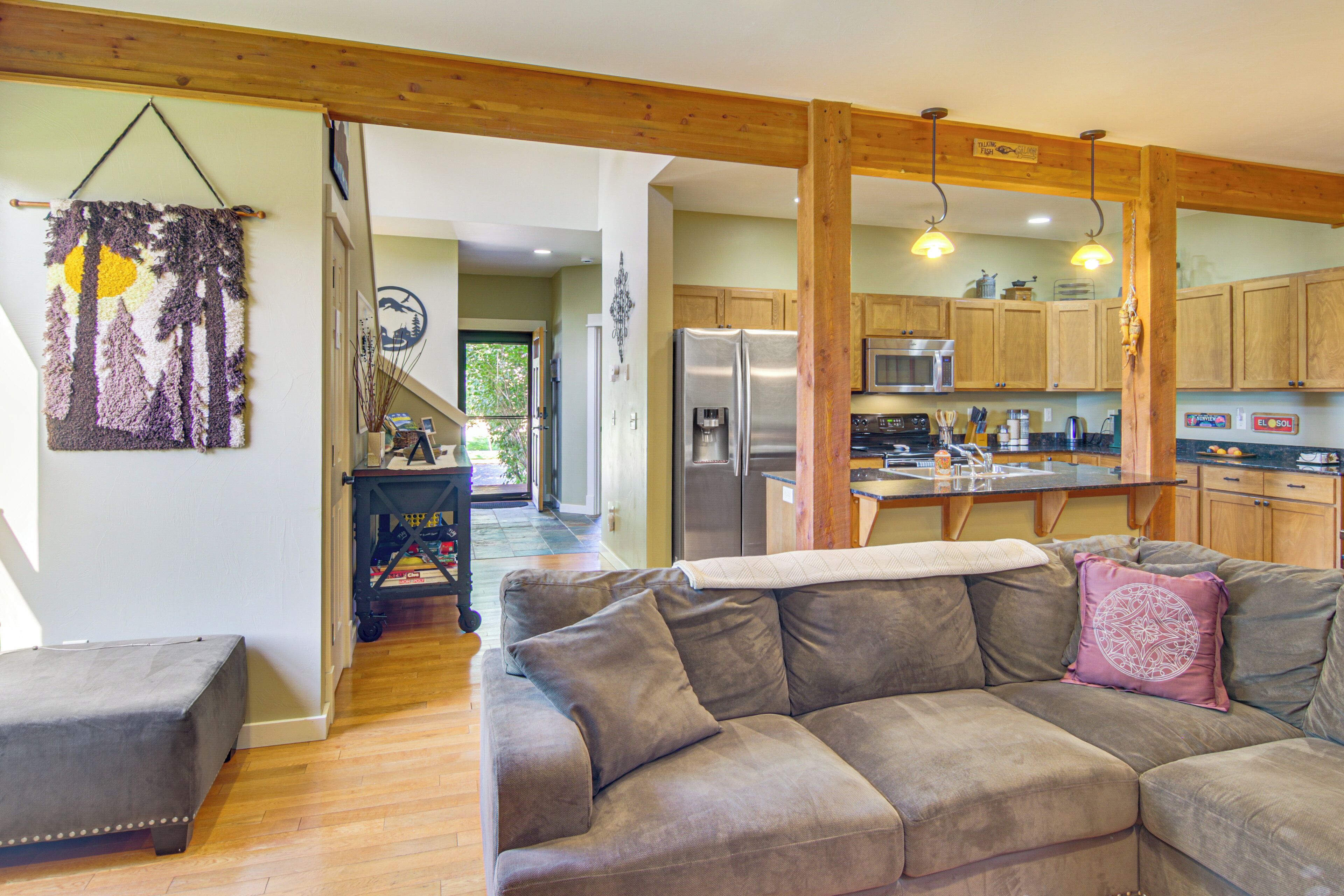 A modern kitchen with wooden cabinets, stainless steel appliances, and a central island.