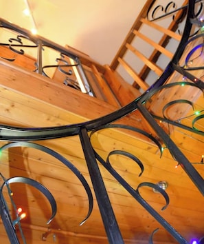 A wooden staircase with metal railings.