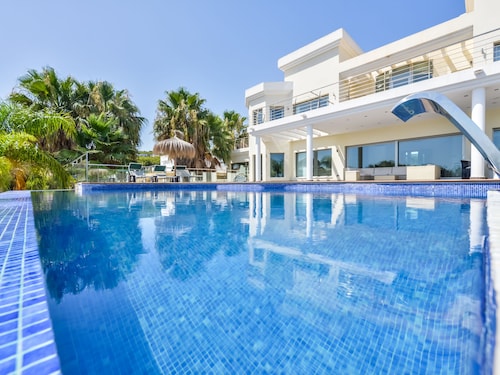 Large modern villa with indoor and outdoor pool sauna and bar.                  