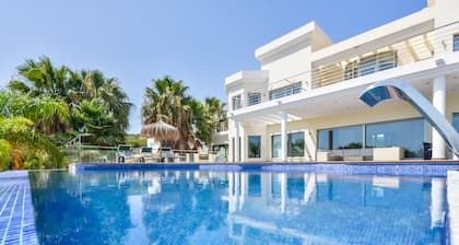 Large modern villa with indoor and outdoor pool sauna and bar.