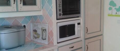 A kitchen with cabinets, a microwave, and a stove.