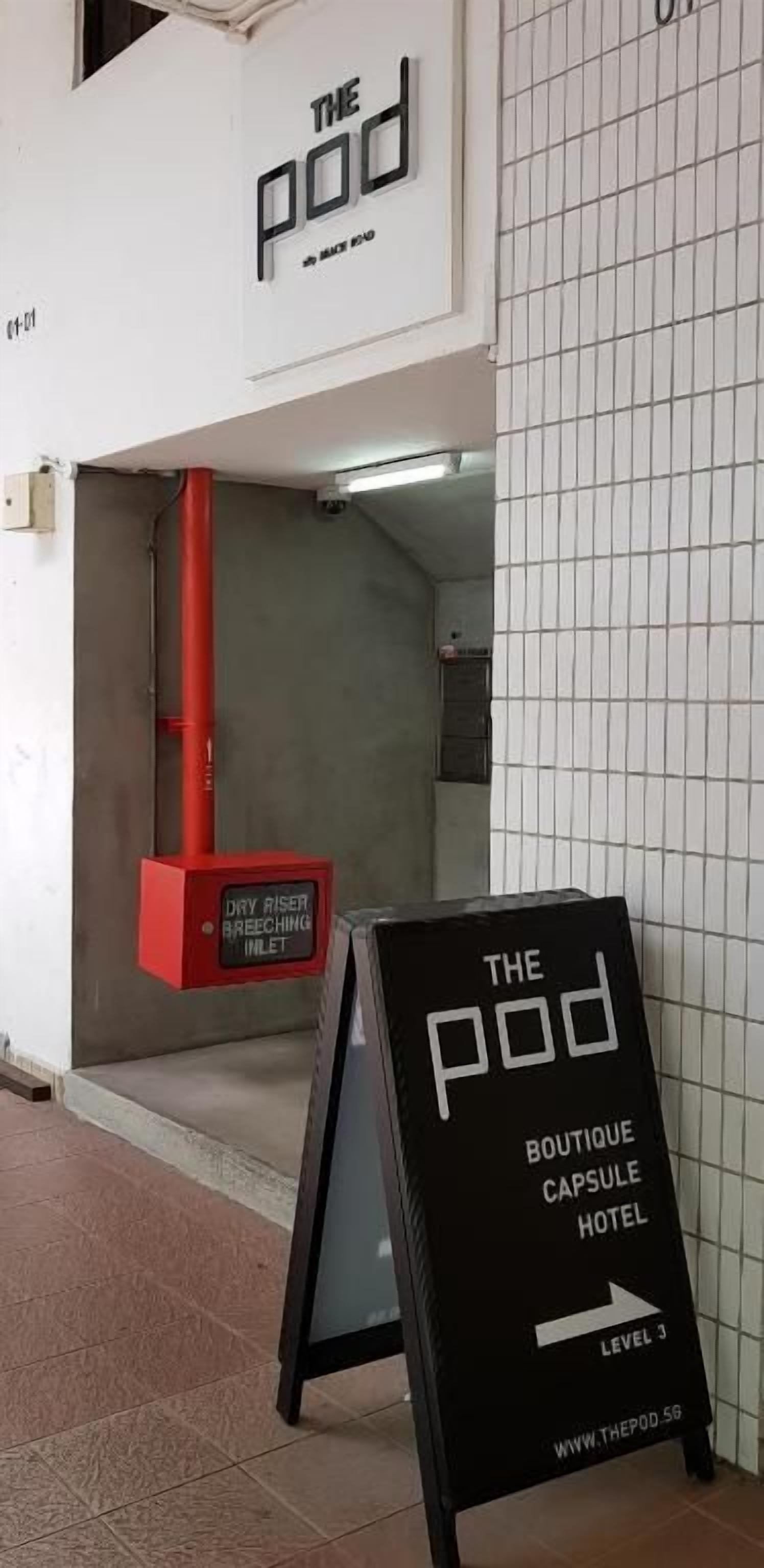 A sign for 'The Pod Boutique Capsule Hotel' indicating Level 3.