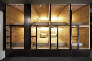 A room with bunk beds, wooden paneling, and a ladder. - Campbell Inn - Hostel (Singapore)