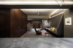 A modern interior with a seating area, a sofa, a chair, and a small table.