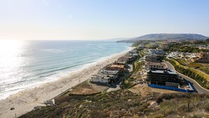 A coastal town with a beach, buildings, and a hilly landscape in the background. - Stunning Multimillion Dollar Whitewater -interior by Artist- special 2026 prices (Dana Point)