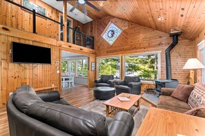 A spacious wooden cabin with a large living area, a fireplace, and a TV mounted on the wall. - Renovated Home/Full Rec Lake/Level lot/Family & Dog friendly/Game Room/Pontoon! (Wautoma)