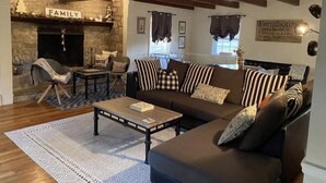 A cozy living room with a fireplace, a sofa set, a coffee table, and a stone fireplace surround. - Country farmhouse !!! (Sinking Spring)