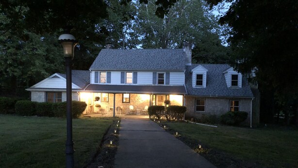 A two-story house with a covered porch, a front yard with a pathway, and a street lamp. - Country farmhouse !!! (Sinking Spring)