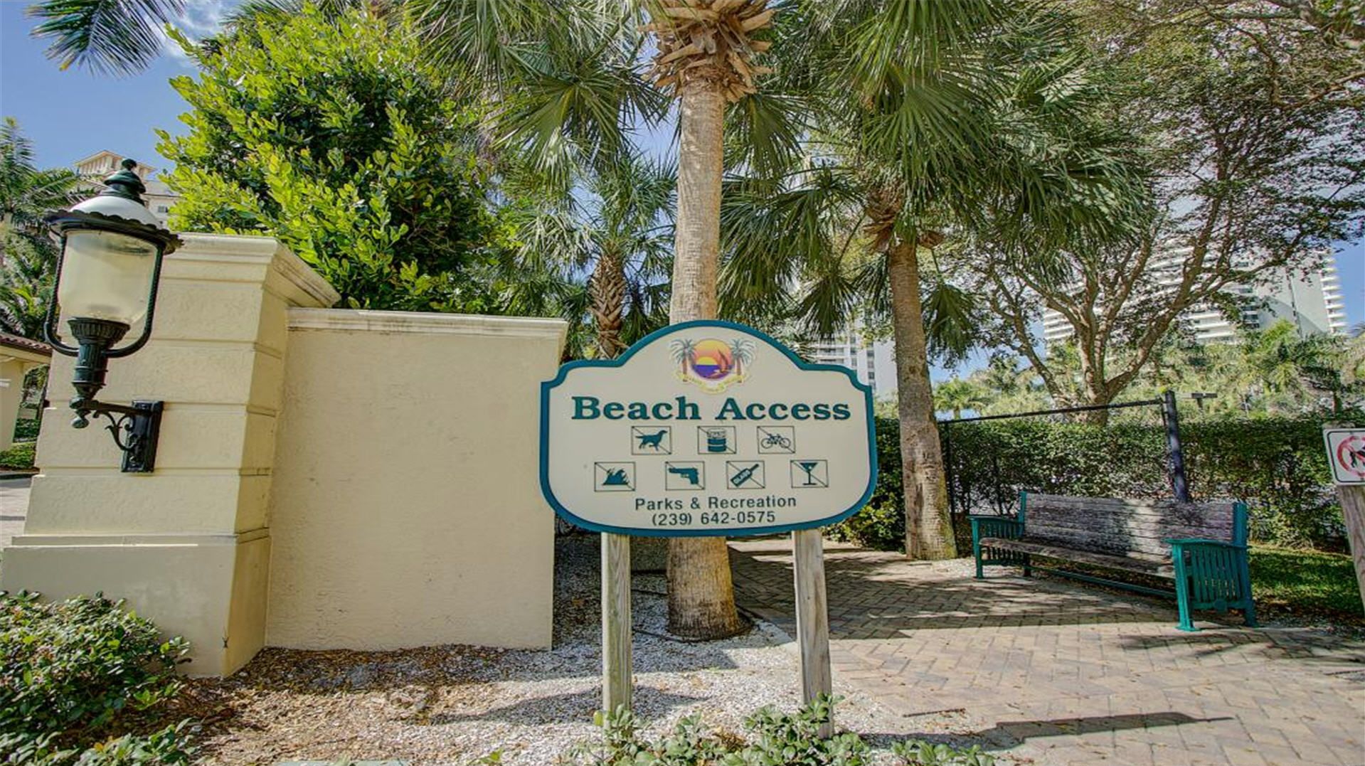 A sign for Beach Access with icons for parks, recreation, and a phone number for Parks & Recreation.