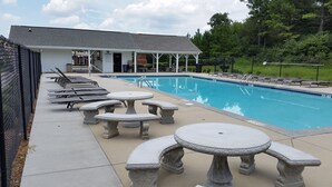 A poolside area with lounge chairs, tables, and a covered seating area. - SPACIOUS Cartersville HOME that SLEEPS UP TO 13 PEOPLE and 12 min. to Lakepoint! (Cartersville)