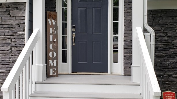 A front entrance with a dark blue door, white steps, and a 'WELCOME' sign. - SPACIOUS Cartersville HOME that SLEEPS UP TO 13 PEOPLE and 12 min. to Lakepoint! (Cartersville)