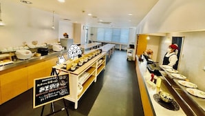 A restaurant with a long counter, multiple dishes displayed, and a signboard with text. - Sabae Dai-ichi Hotel (Sabae)