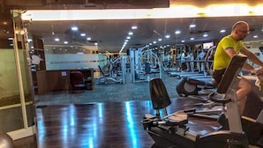 A gym with various exercise equipment, including treadmills and weight machines. - 1 Bedroom Apartment Casa Grande Residence by Travelio (Jakarta)
