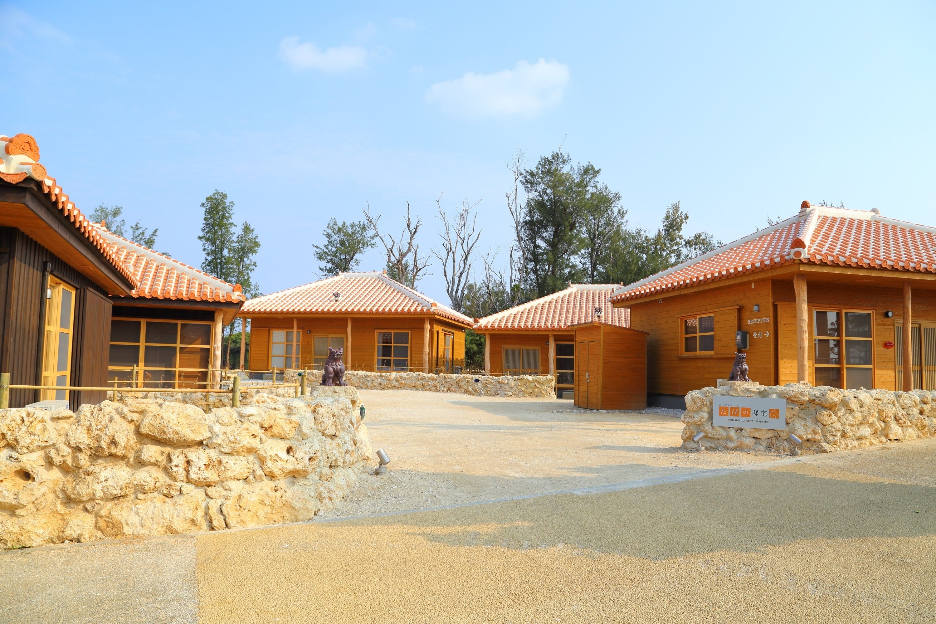A traditional building with a tiled roof, stone walls, and a clear sky.
