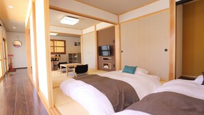 A hotel room with two beds, a television, and a small desk with a chair. - Tabinoteitaku OkinawaNakijin HOMANN CONCEPT (Nakijin)