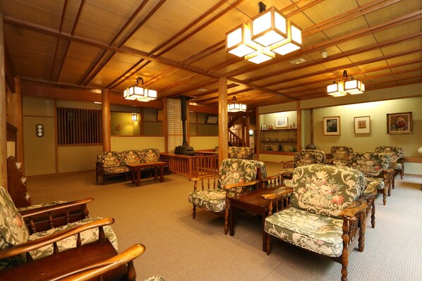 A traditional Japanese-style room with tatami flooring, wooden furniture, and shoji screens.