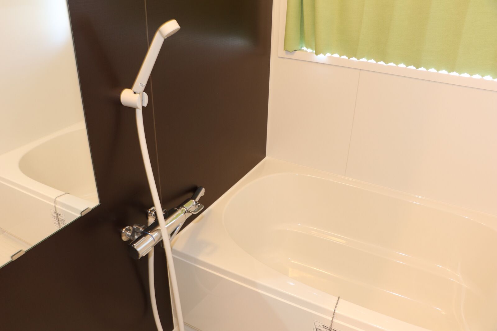 A modern bathroom with a bathtub and a shower area.