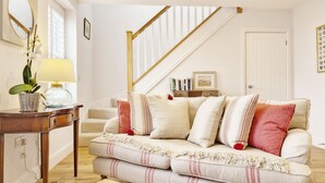 A living room with a sofa, a lamp, a plant, and a staircase. - Castleton , Chichester  - sleeps 2 guests  in 1 bedroom (Chichester)