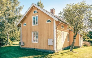 A two-story wooden house with a gabled roof, multiple windows, and a chimney. - 3 bedroom beautiful home in Södra Vi (Södra Vi)