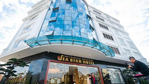 A hotel with a modern facade, large glass windows, and a prominent sign reading "SEA STAR HOTEL". - SeaStar Hotel Ha Long (Bai Chay)