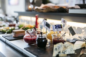 A buffet with various food items including jars of jams, a bowl of soup, and cheese. - Valldal Fjordhotell - by Classic Norway Hotels (Fjord)