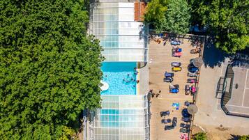 Indoor pool, open 10:00 AM to 7:00 PM, pool loungers