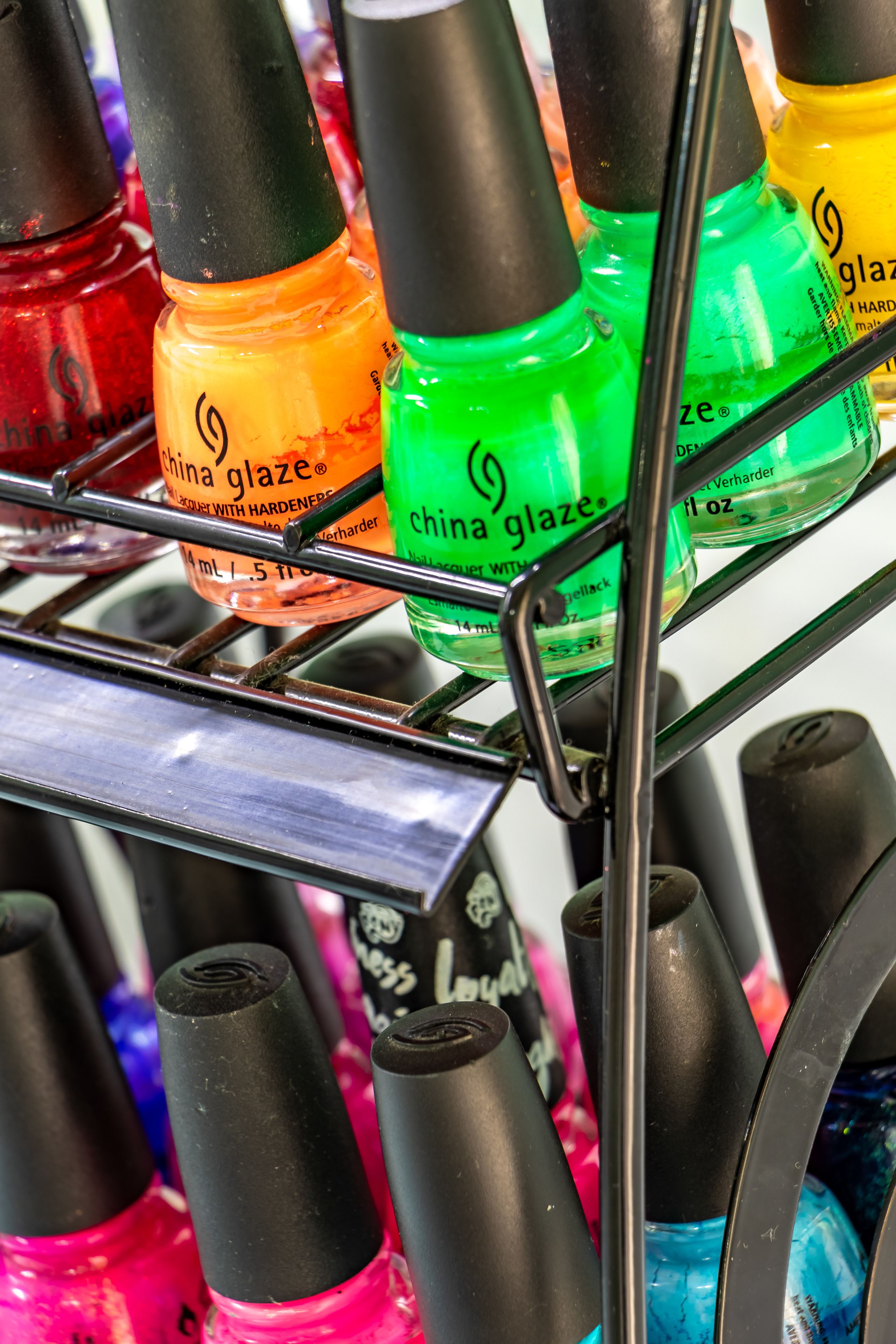 A display of China Glaze nail polish bottles in various colors.