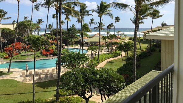 A resort with a pool, palm trees, and a view of the ocean. - Deluxe Room w/King Bd, Ocean/Pool views, New Furnishings!, No Resort Fee (Lihue)