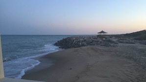 A beach with a gazebo and rocky shoreline. - Pleasure Island Paradise - closest rental to the beach you will find (Kure Beach)