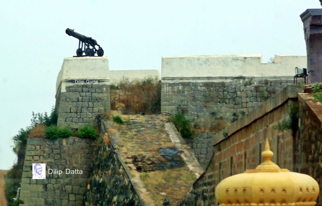A stone fortification with a cannon on top, a staircase leading up, and a yellow dome structure in the foreground.