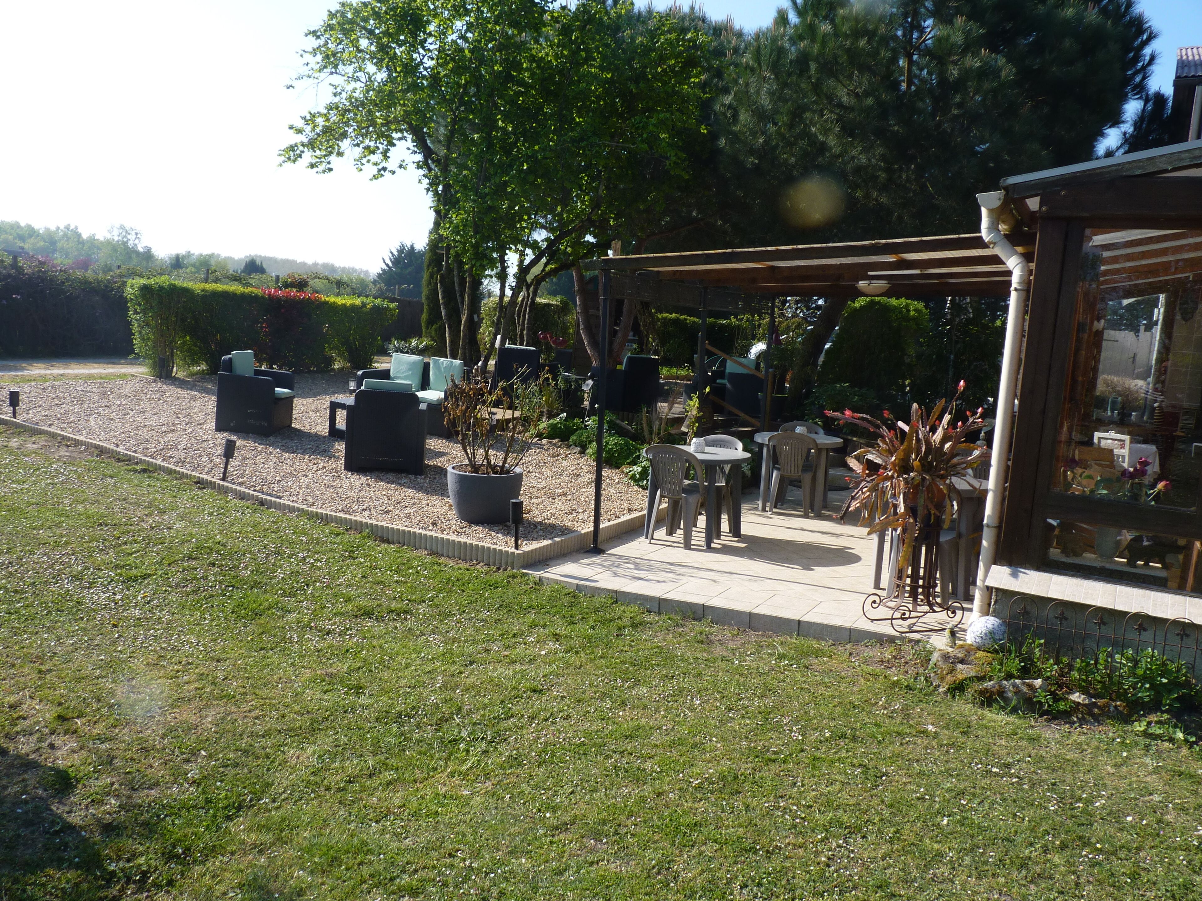 An outdoor patio area with seating arrangements and potted plants.