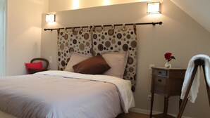 A bedroom with a bed, a nightstand, a chair, and a lamp. - La Ferme du Bois Paris (Ermenonville-la-Petite)