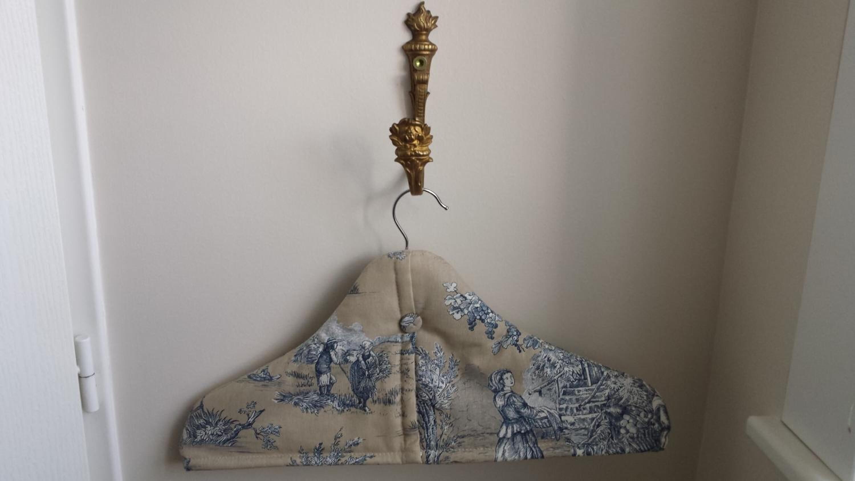 A room with a hanging decorative item featuring a blue and beige pattern.