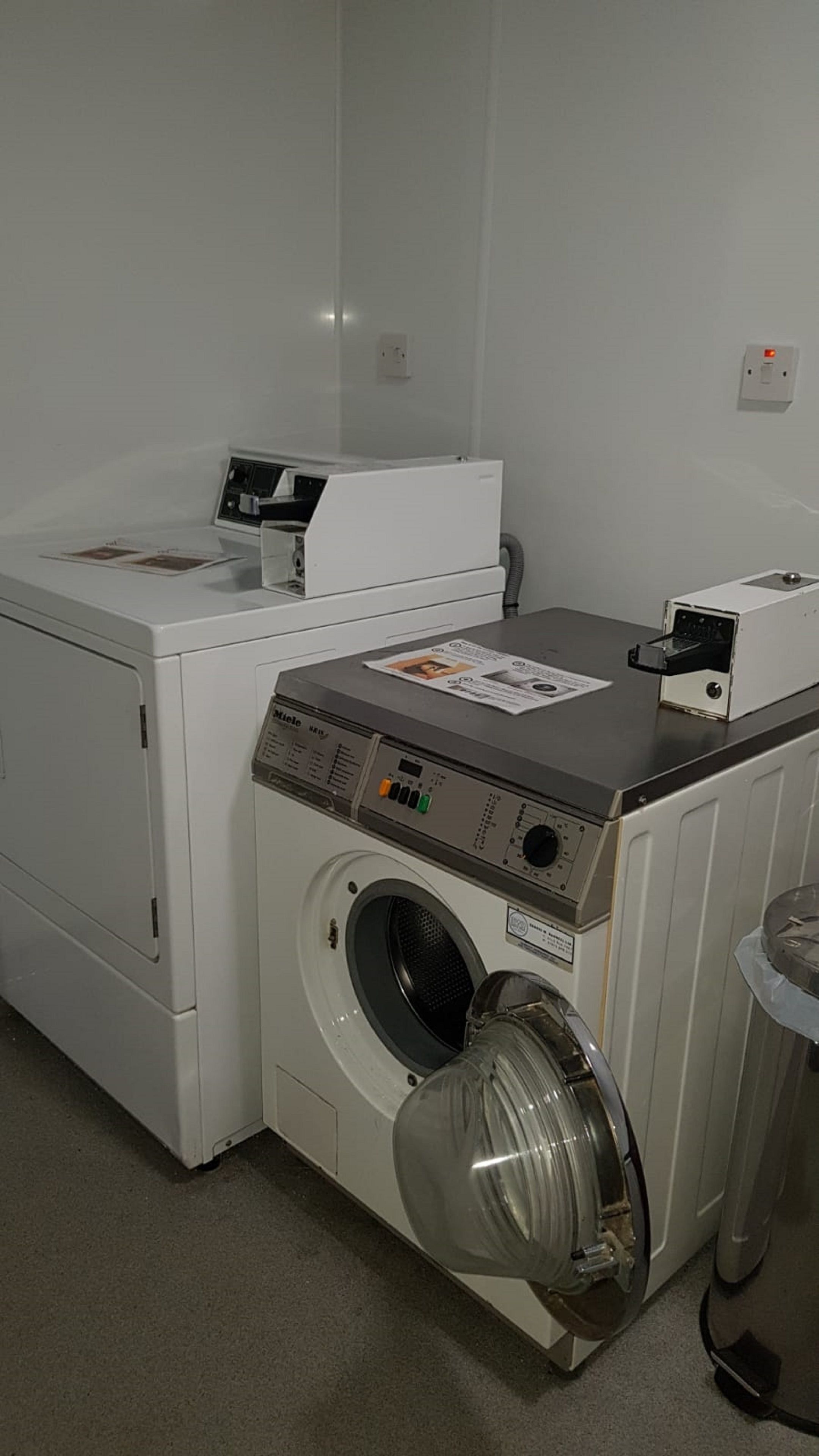 A laundry room with a front-loading washing machine and a dryer.