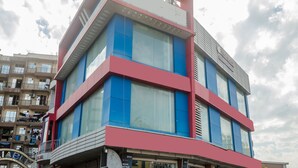 Um edifício alto com grandes janelas e fachada em vermelho e azul.