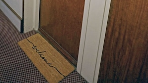 A hotel room door with the number 5, a doorknob, and a small electronic device on the door frame. - Birch at Somerhill (Hove)
