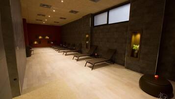 Comfortable rooms feature single beds with headboards and bedside tables.