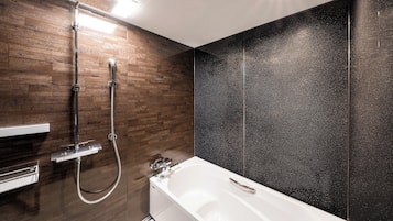 A modern bathroom with a shower, a bathtub, and a vanity with a mirror.