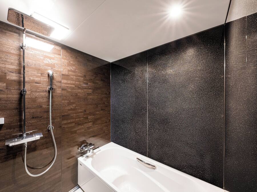 A modern bathroom with a shower, a bathtub, and a vanity with a mirror.