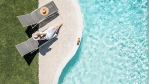 An aerial view of a beach with two sun loungers and a person lying on one of them. - Palatiana Agriturismo Philoxenia Cottages Retreat (Naxos)