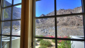 A window view of a mountainous landscape with rocky terrain and sparse vegetation. - Sensational Single Story Townhome Against the Mountains w/ garage, LQ121 (La Quinta)