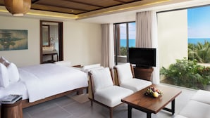 A hotel room with a bed, two sofas, a TV, and a balcony with a view of the sea. - Dusit Princess Moonrise Beach Resort (Phu Quoc)